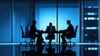 © Kumblack - Silhouetted executives in a highrise office hold a business meeting.