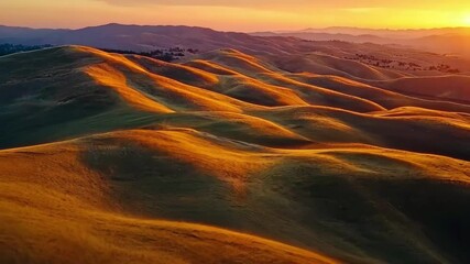 Poster - Stunning orange glow at sunset over rolling hills captured by drone, Beautiful orange sunset glow on hills drone tracking shot