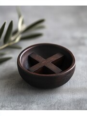 Poster - Minimalist Wooden Bowl with Cross Divider on Grey Surface and Olive Branch Accent