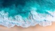 © abid - Aerial view of turquoise waves crashing on a light beige beach.  Detailing the foamy white crests and the deep blue-green water