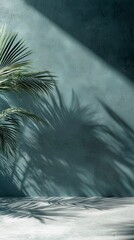 Fototapete - Palm fronds cast intricate shadows on a textured green wall, creating a calm atmosphere in a well-lit interior space. The interplay of light and shadow enhances the tranquility