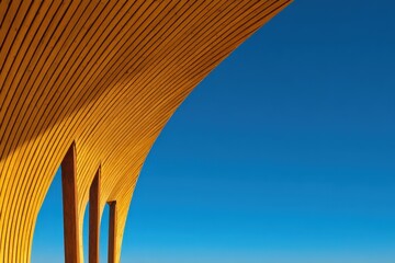 Poster - A modern wooden architectural structure with curved lines set against a clear blue sky.