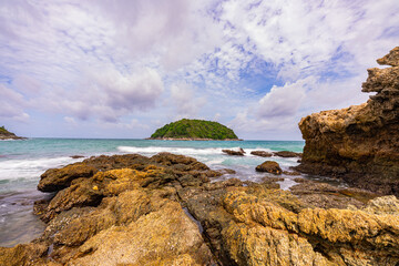 Wall Mural - .Around the island there are large rocks surrounding it. When a big wave hits, the water splashes and bursts into tall foam, looking beautiful and frightening. sandbars connect to the island...