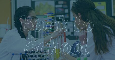 Poster - Image of back to school text over caucasian girls with models in lab