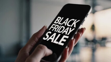 Poster - Woman's hands holding smartphone displaying black friday sale advertisement, suggesting online shopping and deal hunting during seasonal discounts