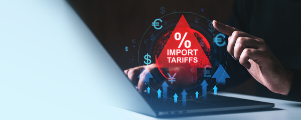 Poster - Businessman analyzing import tariffs with financial icons on laptop in dark office..