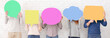 © Prostock-studio - Friends holding speech bubbles with copy space over white wall, crop