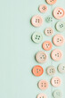 © A2Z AI  - Pastel Buttons on Light Blue Background: A charming display of sewing essentials in delicate hues.