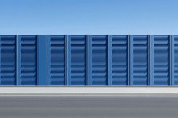 Poster - A striking blue wall with shutter-like design against a clear sky, creating a minimalist and architectural composition.