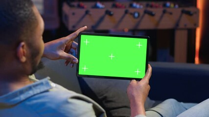 Poster - african american male freelancer holding phone with mockup copy space screen, relaxing on sofa in a 