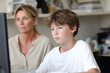 © Ihor - concerned parent monitoring their childs online activity on computer showcasing safe and secure environment