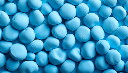 Aufkleber - Background of many light blue round pebble stones, full frame close up.