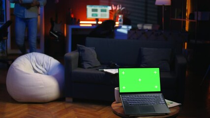 Poster - black young relaxed person having green screen in his trendy loft, stylish living room decorated wit