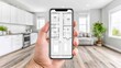 © Atmospheric stock - Smartphone displaying digital floor plan in modern living room setting