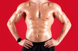© Prostock-studio - Cropped view of handsome young sportsman with bare torso posing with hands on hips over red studio background. Sexy athletic guy with prominent abs muscles, closeup view. Strength workout concept