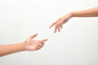 © Setyotuhu - male and female hands reaching towards each other on isolated white background