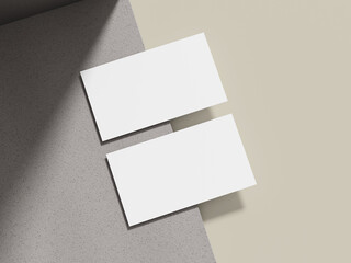 a simple business card mockup placed on a beige cement surface with a sleek shadow, ideal for showca