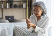 © Art_Photo - Elderly asian woman holding wrist pain, arthritis, health issue, senior female suffering from joint pain at home, expressing discomfort, aging health problem, chronic condition indoor living room