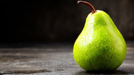 Aufkleber - A close-up view of a single ripe green pear displaying its smooth skin and droplets of water, set against a deep charcoal backdrop with ample copy space