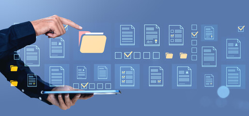 Poster - Digital document management concept with hand pointing at virtual folder icons on blue background.