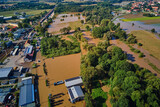 Aerial view of flooded streets, railway tracks and buildings in a suburban area. Industrial zone with floodwater after heavy rain. Concept of natural disaster, climate impact and emergency