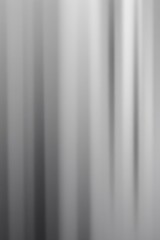 Poster - an abstract grey background featuring a subtle gradient with blurred vertical lines creating a sense of depth and movement.