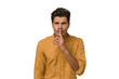 © Asier - Young handsome caucasian man isolated on white background keeping a secret or asking for silence.