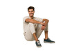 © Asier - Young caucasian man sitting on the floor isolated on white background