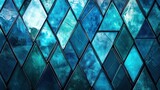 Close-up of textured stained glass wall in blue tones forming a diamond pattern.