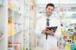 © ultramansk - man pharmacist checks and arranges medicines on pharmacy shelves, emphasizing precision and responsibility in healthcare services. The scene highlights the daily operations in a modern pharmacy.