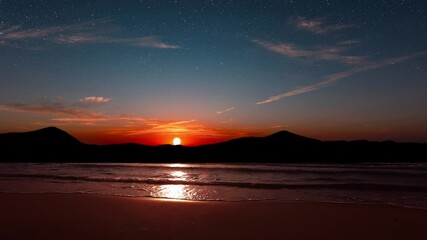 Wall Mural - a a movement of stars in the night sky with the view of mountains.