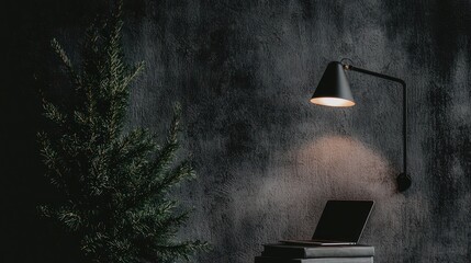 Poster - A black lamp illuminates a laptop near a small evergreen tree