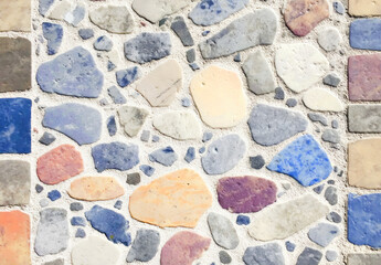 Aufkleber - Colorful mosaic stone wall with various shapes and sizes, creating seamless and artistic pattern. stones are in shades of blue, orange, and beige, adding vibrant touch