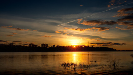 Wall Mural - summer sunset over the river. summer or autumn landscape.