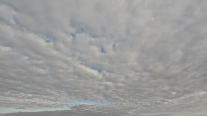 Wall Mural - Incredibly beautiful grey cumulus textured clouds under blue sky on partly cloudy day. Timelapse mode.