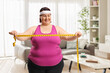 © Ljupco Smokovski - Plus size woman lookgin at a measuring tape