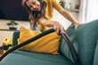 © milanmarkovic78 - Woman Vacuuming Couch