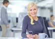 © peopleimages.com - App, phone and smile with portrait of woman employee at desk in office for communication. Mobile, text message and social media with happy designer in creative workplace with break and technology