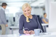 © peopleimages.com - Business woman, phone text and desk with smile and social media break with scroll on website. Mobile, employee and public relations worker with internet, search and message online with technology