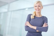 © peopleimages.com - Arms crossed, mockup and portrait with business woman in hallway of office for start of career. Company, smile and space with happy designer in creative workplace for administration or employment