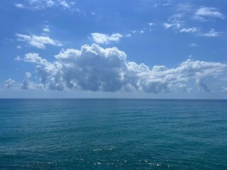 Wall Mural - blue ocean waters and sky beautiful clouds.