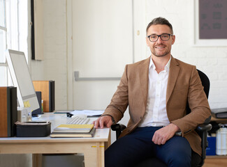 Fototapete - Portrait, computer and man in office, startup and creativity for graphic designer, copywriting and career ambition. Face, person or entrepreneur in workplace, agency or pc with feedback or freelancer