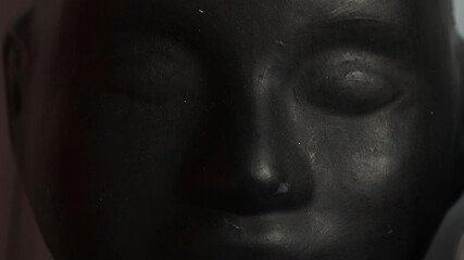 Poster - A detailed view of a person's face on a statue, suitable for artistic or architectural contexts