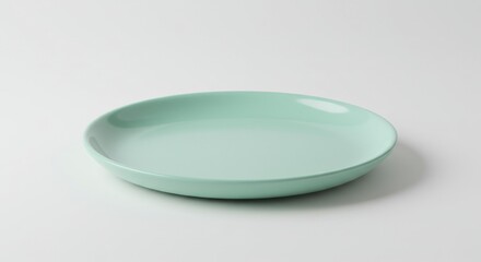 Poster - A light green ceramic plate centered on a white background in a studio setting with soft lighting