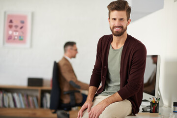 Leinwandbilder - Creative man, portrait and confidence by desk for startup, about us and recruitment in office. Smile, male designer and pride in workplace for success, small business and onboarding and creativity