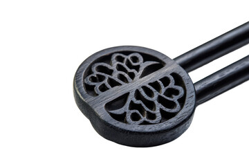 Poster - Close up of a black metal object with intricate circular design against a dark background in a studio shot