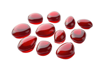 Poster - A collection of red and white translucent beads scattered on a light gray surface with soft shadows around them