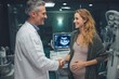 © Marcos Kulenkampff - A doctor and a pregnant woman shake hands, smiling warmly at each other in a clinic.