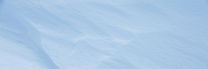 Wall Mural - beautiful winter background with snowy ground. natural snow texture. wind sculpted patterns on snow 