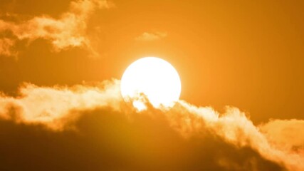 Wall Mural - timelapse of dramatic sunrise with orange sky in a cloudy day.